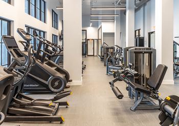 a room filled with cardio equipment and weights at Leena Plantation, Plantation, 33322